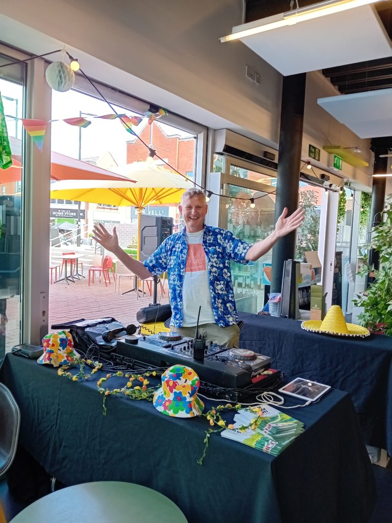 A DJ standing behind decks